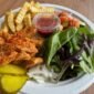 Tandoori chicken platter with French fries, East salad, fresh greens, onions, and pickles at Pita Plus Grill St. Louis