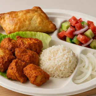 Tandoori chicken platter served with crispy burrekas, pickled vegetables, and dipping sauces at Pita Plus Grill in St. Louis